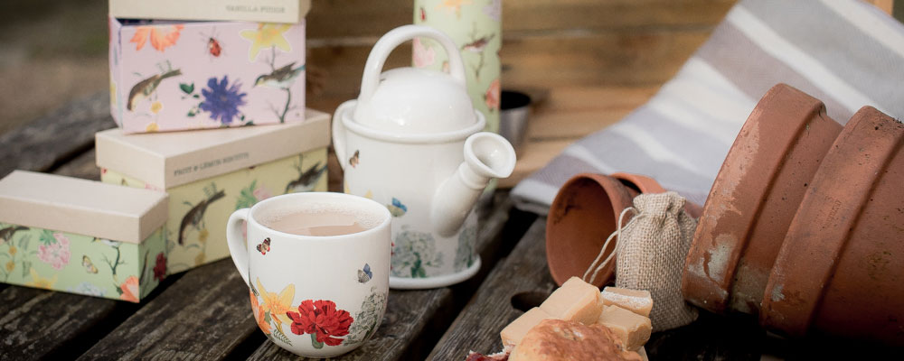 RHS tea set with watering can teapot and tea cup, with gift tea selection boxes